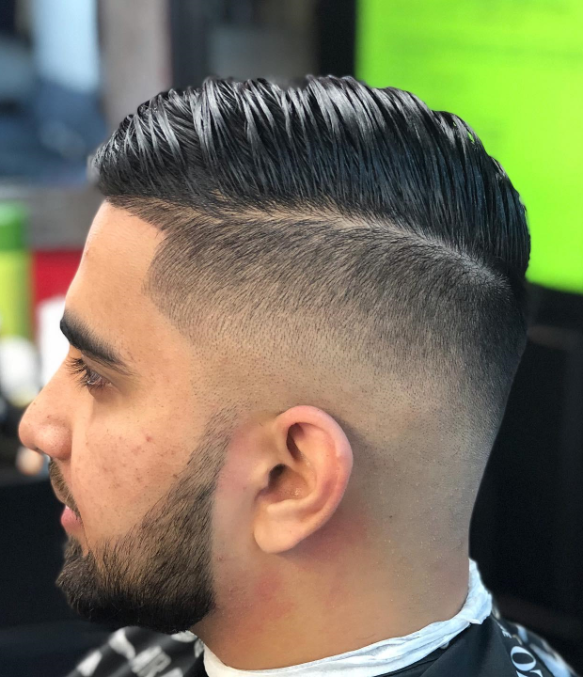 Side profile shot of man getting haircut at Lovera Barbershop